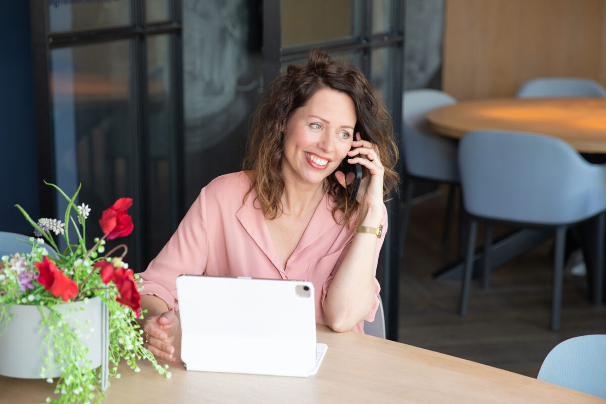 zakenvrouw met laptop aan de telefoon
